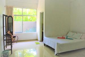 En eller flere senge i et værelse på Samanala Resort