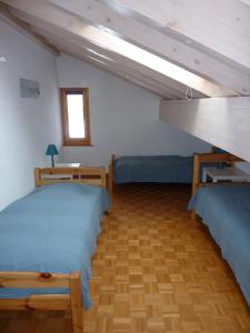 a bedroom with two beds and a loft at Apartments Scierie in Vercorin