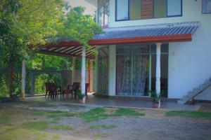 a screened in porch of a house at Samanala Resort in Matara