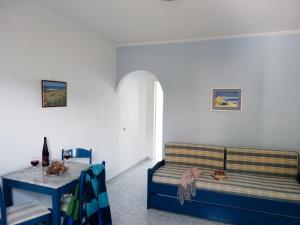 a living room with a couch and a table at Ostria Seaside Studios and Apartments in Katarráktis