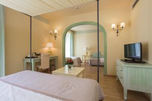 A bed or beds in a room at TH Tirrenia - Green Park Resort