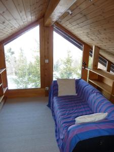 a room with a couch in a room with windows at Chalet Mon Sabot in Vercorin