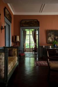 a living room with a couch and a large window at Château d’Orion in Orion