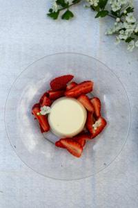 a plate of strawberries and cream on a table at Château d’Orion in Orion