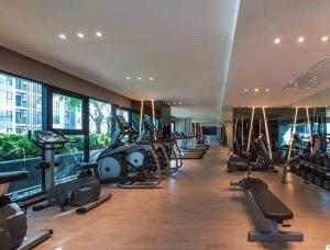 a gym with a bunch of treadms and elliptical machines at the base condo in Pattaya Central