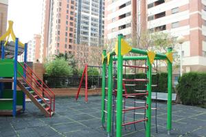a playground with colorful play equipment in a city at Oceanográfico Apartments in Valencia