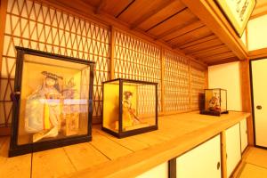 Habitación con 3 cuadros en una estantería de madera en Fuji Sakura House, en Fujikawaguchiko