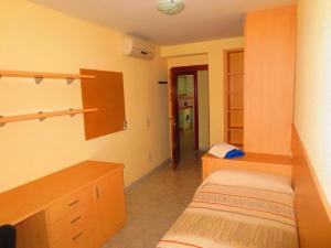 a room with two beds and a desk and a room with at ApartamentosAlquilerZaragoza in Zaragoza