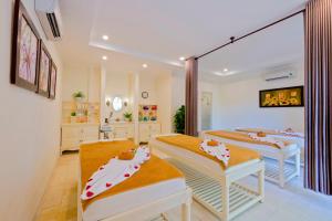 a hospital room with two beds and a mirror at Hoi An Garden Palace & Spa in Hoi An