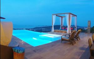 a villa with a swimming pool at night at 8 Bedroom Sea Blue View Villa SDV080B - 5 Star with Staff-By Samui Dream Villas in Bophut 