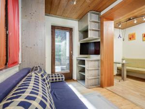 a room with a bed and a tv and a desk at Apart Gentiana in Sölden
