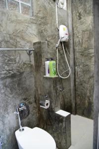 a bathroom with a shower with a toilet and a sink at Tk Home 3 in Lampang