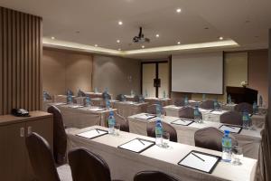 una sala de conferencias con mesas y sillas y botellas. en S Aura Hotel, en Taipéi