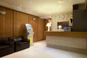 a waiting room with a atm machine in a store at Cosmotel Hotel in Paris