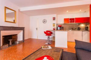 a living room with a couch and a fireplace at L'Entrecasteaux in Aix-en-Provence