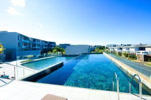 a large swimming pool on the roof of a building at Azuri Resort -Sea View & Golf Luxury Apartment in Roches Noires
