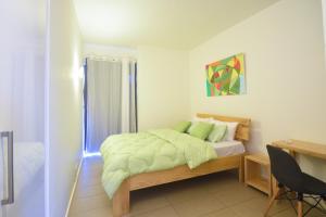 a bedroom with a bed with green pillows and a desk at Azuri Resort -Sea View & Golf Luxury Apartment in Roches Noires +25 photos