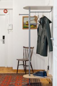 a coat rack and a chair in a room at Apartment Bergen Central in Bergen