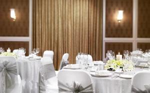 a dining room with white tables and chairs at Jai Mahal Palace in Jaipur +50 photos