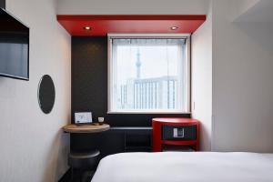 Postel nebo postele na pokoji v ubytování the b asakusa