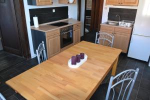 a kitchen with a wooden table with shoes on it at Schöne‘s Eck in Großröhrsdorf