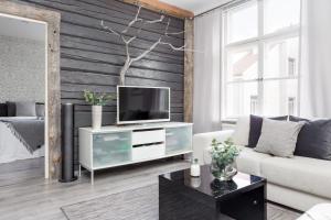 a living room with a tv on a white cabinet at Central Alexandra in Tampere