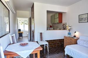 a living room with a table and a couch at Guesthouse Antonija in Veli Lošinj