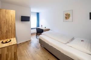 Voodi või voodid majutusasutuse HotelChur.ch toas