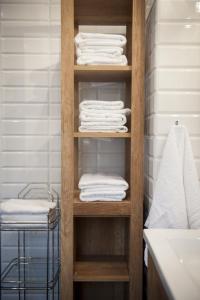 a towel rack with towels in a bathroom at Brzezina Resort - Wille in Żnin
