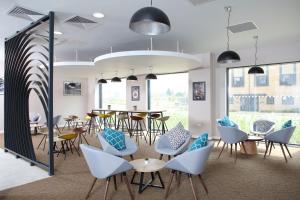 a dining room with chairs and tables and a table and chairsearcher at Sunley Hotel in Northampton