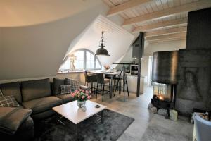 a living room with a couch and a fireplace at "Kontorhaus" by Ferienhaus Strandgut in Born