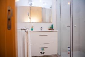 a bathroom with a sink and a shower at Peter Five Flat by TonsdeVerde in Braga