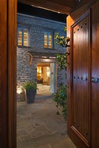 an entrance to a brick building with a door at 5 Senses in Dikoryfo +44 photos