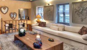 a living room with a couch and a coffee table at 5 Senses in Dikoryfo