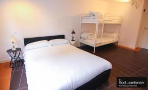 a bedroom with a bed and a dresser at Enjoy Santander in Santander