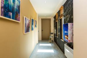 a hallway with paintings on the walls and a ladder at Villa Evgoron in Zourídhion