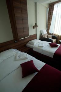 Postel nebo postele na pokoji v ubytování Hotel Luka's