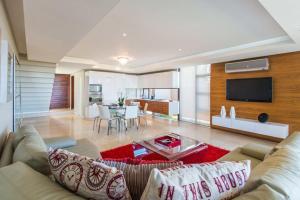 a living room with a couch and a dining room at Zimbali Luxury 3 Bedroom Villa KB01 in Ballito