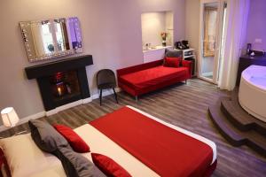 a living room with a red couch and a fireplace at MILLINA SUITES IN NAVONA in Rome