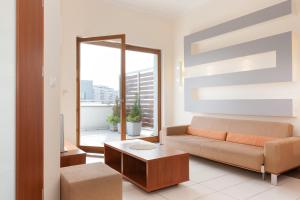 a living room with a couch and a table at Apartments Świnoujście Center II by Renters in Świnoujście