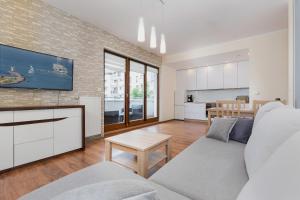 a living room with a couch and a table at Apartments Świnoujście Center II by Renters in Świnoujście