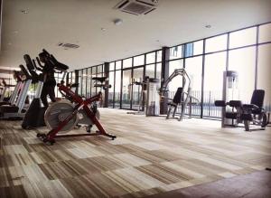 a gym with treadmills and machines in a building at Trefoil Setia Alam- Simple No 5- Near Setia City Mall & Convention Centre in Setia Alam