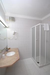 a bathroom with a sink and a shower at Hotel Baia Del Sorriso in Castiglioncello