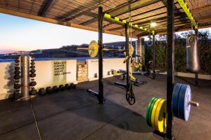 a gym with dumbbells and weights at Paros Agnanti Resort & Spa in Parikia