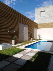 a swimming pool in front of a house at Garden 33 in Chivilcoy