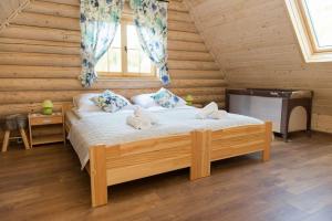 a bedroom with a bed with stuffed animals on it at Cicha Polana in Szczyrk +47 photos