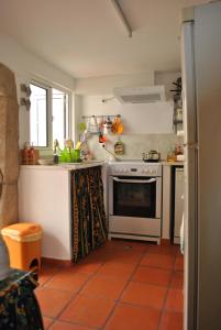 uma cozinha com um fogão branco forno superior ao lado de uma janela em Casa típica alentejana em Alpalhão