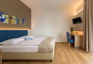 Łóżko lub łóżka w pokoju w obiekcie Hotel am See Rust