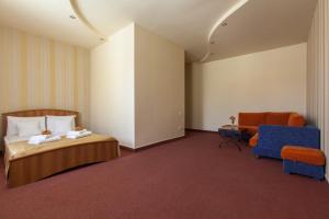 a hotel room with a bed and a chair at Best Western Bohemian Resort in Sevan