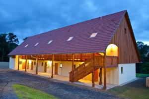 a large barn with a large brown roof at JUFA Hotel Tieschen in Tieschen